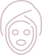 An outline illustration of a face with a facial mask applied and a towel wrapped around the head, commonly representing a facial or spa treatment. The illustration is simple and minimalistic, using pink lines on a transparent background.
